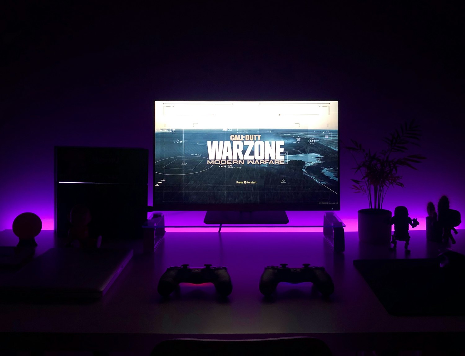 A console gaming lounge with controllers and a big-screen game
